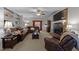 Cozy living room features a brick fireplace, built-in shelving and comfortable leather furniture at 2005 Bridgeport Dr, Raleigh, NC 27615