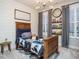 Bedroom featuring a modern light fixture, large clock, a bookshelf and motorcycle themed bedding at 2036 Big Falls Dr, Wendell, NC 27591