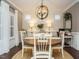 Bright dining area with a round table, white wooden chairs, and a unique globe chandelier at 2036 Big Falls Dr, Wendell, NC 27591