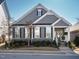 Charming home features a gray exterior, inviting front porch, and manicured landscaping at 2036 Big Falls Dr, Wendell, NC 27591