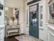 Welcoming foyer with a decorative mirror, console table, dark wood floors, and a blue front door at 2036 Big Falls Dr, Wendell, NC 27591