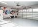 Clean garage with storage solutions, work bench, and a large sectional garage door at 2036 Big Falls Dr, Wendell, NC 27591