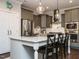 Modern kitchen featuring gray cabinets, stainless steel appliances, and a large island with seating at 2036 Big Falls Dr, Wendell, NC 27591
