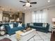 Open-concept living room featuring plush sofas, a decorative rug, and seamless flow to the kitchen at 2036 Big Falls Dr, Wendell, NC 27591