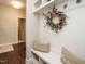 Mudroom with built-in storage bench, hooks, a decorative wreath, and tile flooring at 2036 Big Falls Dr, Wendell, NC 27591