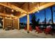 Inviting outdoor seating area featuring string lights, wooden beams, and cozy red chairs, perfect for relaxation at 2036 Big Falls Dr, Wendell, NC 27591