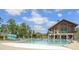 Community pool area features waterslide, fountains, sun loungers, and a rustic style clubhouse for a relaxing time at 2036 Big Falls Dr, Wendell, NC 27591