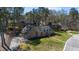 Aerial view of a brick home with mature landscaping, a driveway, and a green lawn at 209 Ashmore Ln, Rocky Mount, NC 27804