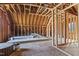 Unfinished attic space with exposed wood beams and framed walls, ready for customization at 209 Ashmore Ln, Rocky Mount, NC 27804