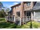 Outdoor wooden deck featuring black metal railings and access to the brick home at 209 Ashmore Ln, Rocky Mount, NC 27804