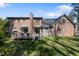 View of the back of the brick home with a wooden deck and a well-maintained lawn at 209 Ashmore Ln, Rocky Mount, NC 27804