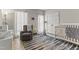 Bright, cozy Bedroom with a crib, rocking chair, and decorative rug at 209 Ashmore Ln, Rocky Mount, NC 27804