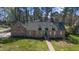 Charming brick home with dormer windows and a well-manicured front yard with mature tree coverage at 209 Ashmore Ln, Rocky Mount, NC 27804