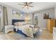 Well-lit primary bedroom features a bed with plush bedding and wood flooring at 209 Ashmore Ln, Rocky Mount, NC 27804