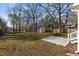Expansive backyard with mature trees, a storage shed, and a concrete patio area at 211 W Sycamore, Zebulon, NC 27597