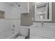 Bright bathroom featuring a shower-tub combination, white vanity with quartz counters, and mosaic tile accents at 211 W Sycamore, Zebulon, NC 27597