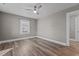 Cozy bedroom featuring wood floors, a ceiling fan, and plenty of natural light at 211 W Sycamore, Zebulon, NC 27597