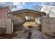 Spacious carport with gravel driveway and wooden fencing, offering ample covered parking at 211 W Sycamore, Zebulon, NC 27597