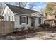 Quaint home featuring updated windows, manicured landscaping, and a welcoming covered porch at 211 W Sycamore, Zebulon, NC 27597