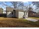 Back view of home with siding, small windows, and fenced in backyard with patio at 211 W Sycamore, Zebulon, NC 27597