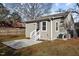 View of the back of the house, featuring a patio, back door, and well-manicured yard at 211 W Sycamore, Zebulon, NC 27597