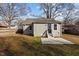 Back of house with a door, patio, small windows, and siding next to a fenced backyard at 211 W Sycamore, Zebulon, NC 27597