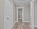 Hallway with several white doors, leading to rooms, and featuring modern light gray paint with white trim at 211 W Sycamore, Zebulon, NC 27597