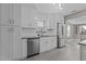 Modern kitchen with stainless steel appliances, white cabinets, and subway tile backsplash at 211 W Sycamore, Zebulon, NC 27597