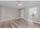 Bright living room with wood floors, modern ceiling fan, and natural light at 211 W Sycamore, Zebulon, NC 27597