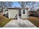 View of the house's rear featuring a patio, stairs, and simple design at 211 W Sycamore, Zebulon, NC 27597
