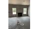 Bright living room showcasing a modern fireplace, drywall, and dual windows bringing in natural light at 228 Dove Rd, Cameron, NC 28326