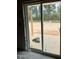 Large sliding glass door allows for natural light and beautiful views of the wooded backyard at 228 Dove Rd, Cameron, NC 28326