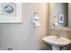 Elegant powder room with a pedestal sink, silver accents, and modern artwork at 2469 Englemann Dr # 366, New Hill, NC 27562
