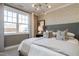 Relaxing bedroom featuring a large window, geometric wallpaper, and stylish contemporary lighting at 2469 Englemann Dr # 366, New Hill, NC 27562