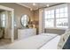 Bright bedroom featuring a modern ceiling fixture, dresser and a large sunlit window at 2469 Englemann Dr # 366, New Hill, NC 27562