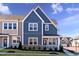 Charming townhome showcasing blue siding, white trim, stone accents, and a welcoming front porch at 2469 Englemann Dr # 366, New Hill, NC 27562