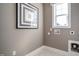Bright laundry room with artwork, window and white trim, ready for washer and dryer hookups at 2469 Englemann Dr # 366, New Hill, NC 27562