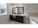 Bright bathroom featuring a double vanity with a large mirror and abundant natural light at 2523 Spring Oaks Way, Raleigh, NC 27614