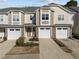 Charming townhome with stone accents, two-car garage, and cozy front porch in a desirable community at 2523 Spring Oaks Way, Raleigh, NC 27614