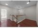 Open hallway with hardwood floors, chandelier, and wood staircase at 2523 Spring Oaks Way, Raleigh, NC 27614