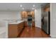 Functional kitchen with stainless steel appliances, wood cabinets, and hardwood floors at 2523 Spring Oaks Way, Raleigh, NC 27614