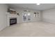 Spacious living room featuring a cozy fireplace, neutral carpet, and French doors to the patio at 2523 Spring Oaks Way, Raleigh, NC 27614