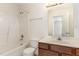 Simple bathroom showcasing a tub with shower and single sink vanity at 2608 Broad Oaks Pl, Raleigh, NC 27603