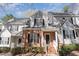 Charming townhouse with brick facade, gray siding, black shutters, and well-maintained front landscaping at 2608 Broad Oaks Pl, Raleigh, NC 27603