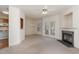 Inviting living room with fireplace, ceiling fan, and sliding doors to a porch or patio area at 2608 Broad Oaks Pl, Raleigh, NC 27603