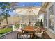 Outdoor back deck with table, umbrella, and wicker chairs at 2613 Forest Lake Ct, Wake Forest, NC 27587