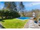 Beautiful backyard featuring a swimming pool, lounge chairs, and grass at 2613 Forest Lake Ct, Wake Forest, NC 27587