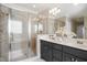 Bright bathroom featuring double vanity with modern fixtures and a large glass shower at 2613 Forest Lake Ct, Wake Forest, NC 27587