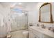 Simple bathroom featuring white fixtures, a shower with a glass door, and an ornate mirror at 2613 Forest Lake Ct, Wake Forest, NC 27587