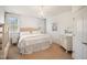 Bright bedroom with soft pink accents, including a tufted headboard and plush bedding at 2613 Forest Lake Ct, Wake Forest, NC 27587